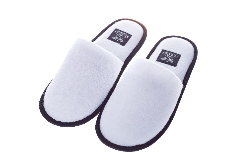 white hotel room slippers